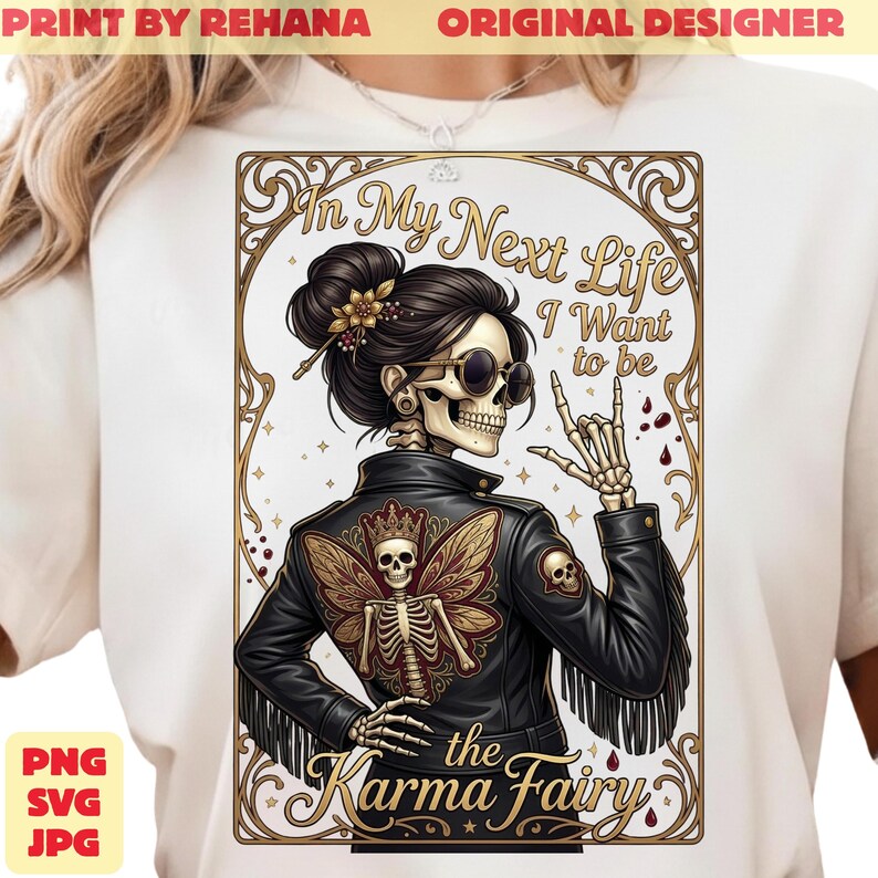 May include: White t-shirt featuring a detailed illustration of a skeleton in a black leather jacket with a butterfly wing design. The text reads "In My Next Life I Want to be the Karma Fairy". The design includes gold and brown accents.