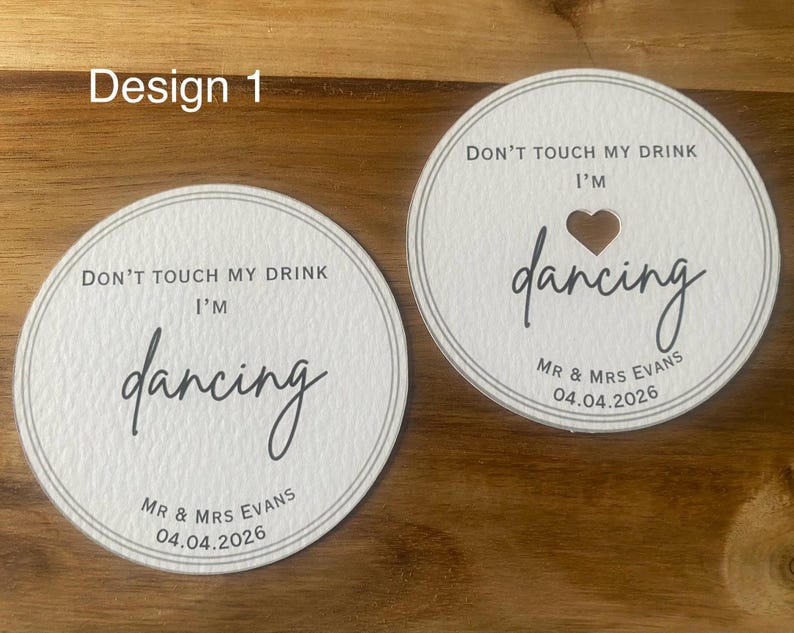 May include: A white ceramic mug with a black handle and the text "But First, Coffee" in a black, bold font. The mug is on a white surface.