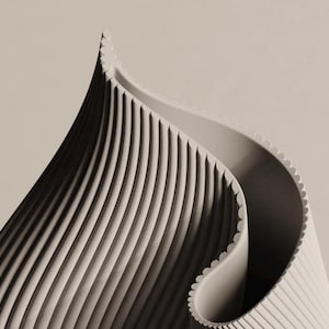 May include: Abstract image of a beige, curved, ridged structure with a pointed top. The design features vertical lines and a scalloped edge, creating a sense of depth and texture. The overall aesthetic is minimalist and modern.