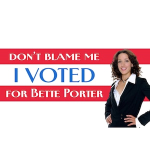 May include: A rectangular sign with a red and white striped background featuring the text DON'T BLAME ME I VOTED FOR BETTE PORTER in blue and white lettering, alongside a photograph of a person with curly brown hair wearing a black blazer.