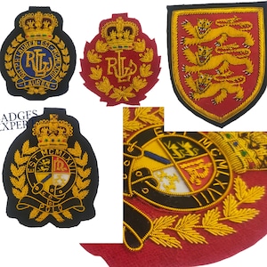 May include: A collection of embroidered patches in various shapes and colours. Designs include a shield with three lions, a crest with the letters "RL", and a circular emblem with text and a crown. Gold and yellow thread is used.