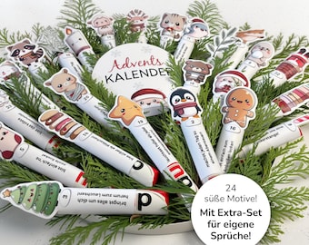 May include: An Advent calendar with 24 decorative pens, each adorned with a different festive character, including a penguin, gingerbread man, and star. The pens are arranged with greenery and the words "Advents KALENDER" are visible.