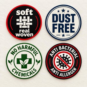 May include: Four circular labels with white backgrounds and colored borders. Top left: black with 'soft real woven' text and a grid icon. Top right: blue with 'DUST FREE' text and stars. Bottom left: green with 'NO HARMFUL CHEMICALS' and a cross icon. Bottom right: red with 'ANTI BACTERIAL ANTI ALLERGEN' text and a virus icon with a slash.