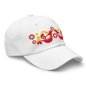 May include: White baseball cap with a curved brim. The cap features an embroidered design of two red birds with yellow accents and red flowers. The design is on the front left side of the cap.