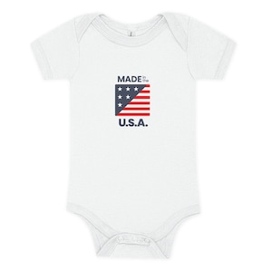 White baby onesie with Made in the USA on it in red whte and blue with a small flag.