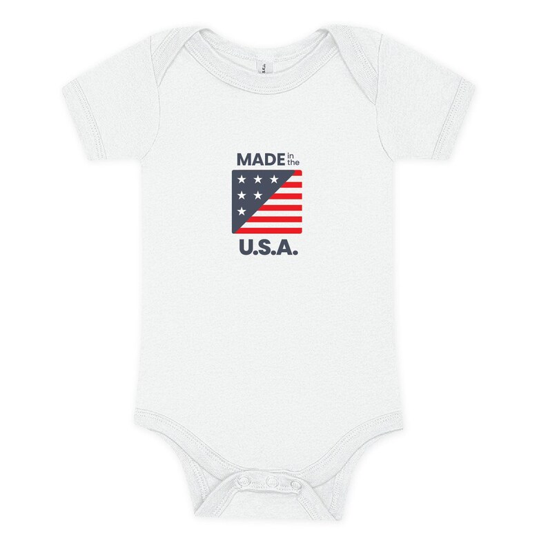 White baby onesie with Made in the USA on it in red whte and blue with a small flag.