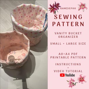 May include: Two fabric vanity bucket organisers, one large and one small, with a floral pattern. The interior lining is also patterned with pink flowers. The image includes text that says "SEWING PATTERN" and "VANITY BUCKET ORGANIZER".