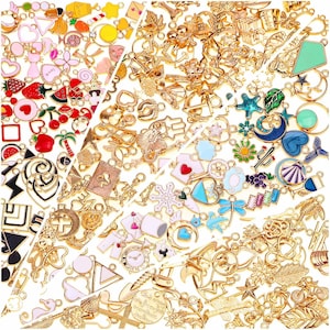 May include: A large collection of assorted metal charms in various shapes and sizes, featuring gold-tone finishes and colourful enamel accents. The charms include motifs such as fruits, animals, celestial bodies, flowers, and geometric shapes.