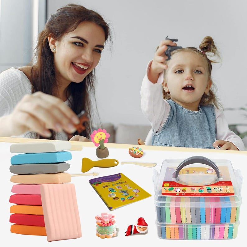 May include: A clear plastic carrying case filled with colorful modeling clay, with a variety of tools and accessories. The image also shows a stack of clay in various colors, along with a smiling woman and a young child.