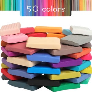 May include: A collection of 50 colorful clay bars in various shades, including pink, red, orange, yellow, blue, purple, and green. The clay bars are stacked together, with the text "50 colors" displayed above.