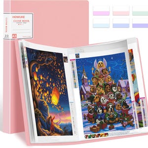 May include: A peach pink A3 clear book with 30 pockets, featuring a label that reads HOWUKE CLEAR BOOK. The open folder displays two diamond painting art pieces: one showing a person releasing floating lanterns and another with many dogs.