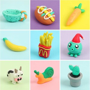 May include: A collection of colorful clay food and animal sculptures. Includes a teal bowl, a hot dog, a carrot, a banana, a container of fries, an octopus with a Santa hat, a cow, a snail, and a cactus in a pot.