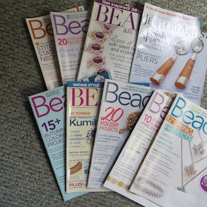 May include: A stack of Bead & Button magazines featuring various beading projects and techniques. The magazines have colorful covers with titles like "20 Holiday Projects", "10 Stunning Jewelry", and "12 Spring Projects".