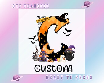 May include: A Halloween-themed DTF transfer design featuring a large letter "C" in orange and black, adorned with bats, a witch's hat, a haunted house, and a black cat. The word "Custom" is displayed below, with "Happy Halloween" text above.