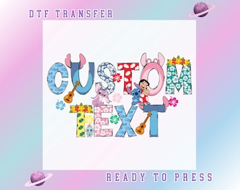 May include: DTF transfer design featuring the words "CUSTOM TEXT" in colorful, patterned letters with cartoon characters and ukuleles. The design includes the text "READY TO PRESS" and is set against a gradient background with planets.