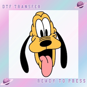 May include: A DTF transfer featuring a cartoon image of Pluto, the Disney dog, with a yellow head, black ears, and a pink tongue. The text "DTF TRANSFER" and "READY TO PRESS" are displayed in purple. The background has a pastel gradient.
