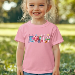 Ready to press custom name DTF transfer featuring bright multi-color text design for unique apparel.