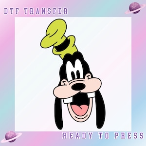 May include: DTF transfer featuring a cartoon character with a black face, large ears, and a green hat. The character is smiling with its mouth open, revealing teeth and a pink tongue. The words "DTF TRANSFER" and "READY TO PRESS" are displayed.