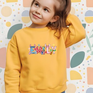 Personalized DTF transfer with custom text option, bold rainbow letters, and DIY heat transfer style.