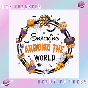 May include: A DTF transfer design with the text "Snacking Around The World" in black and orange, surrounded by cartoon food items like cupcakes, pizza, and candy corn. The design includes bats, spiders, and a planet graphic. The words "Ready To Press" are also included.