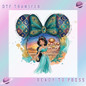 May include: DTF transfer featuring a teal bow with peacock feather details and a jewel center. The design includes a watercolor illustration of Princess Jasmine holding a lamp, set against a desert backdrop. Text reads "DTF TRANSFER" and "READY TO PRESS".