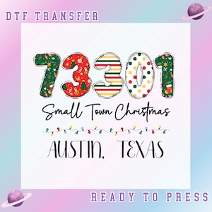 May include: A white graphic featuring the text "73301 Small Town Christmas Austin, Texas". The numbers are adorned with festive Christmas designs. The words "DTF TRANSFER" and "READY TO PRESS" are also visible.