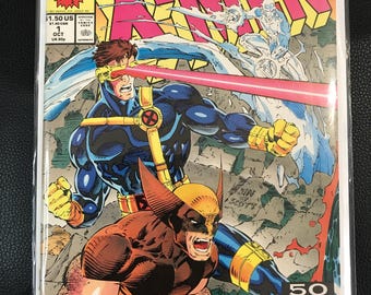 May include: X-Men comic book cover featuring Cyclops, Wolverine, and Silver Surfer. The cover art is vibrant with action poses and bold colors. The comic is labeled "1st Issue! A Legend Reborn!" and includes the Marvel Comics logo and a "Mutant Milestone" banner.