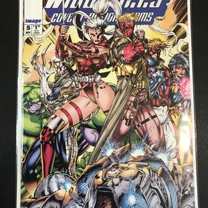 May include: A WildC.A.T.S. comic book cover featuring several costumed characters in action poses. The cover art is vibrant with a mix of reds, blues, and yellows. The title is prominently displayed at the top, with issue details in the corner.