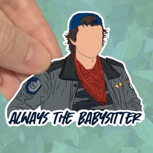 May include: A sticker featuring a stylized illustration of a person wearing a blue cap, red bandana, and gray jacket. The text "ALWAYS THE BABYSITTER" is printed in white below the illustration.