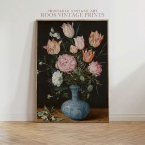 May include: A framed vintage floral still life print. The artwork features a bouquet of pink and white roses and tulips in a blue vase against a dark background. The text "PRINTABLE VINTAGE ART ROOS VINTAGE PRINTS" is at the top.