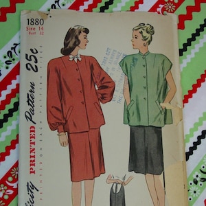 May include: Vintage Simplicity sewing pattern for a dress, size 14, bust 32. The pattern is printed on a cream-colored paper with a green and red checkered background. The pattern includes instructions for making a dress with a collar and a skirt.