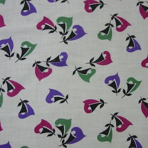 May include: A fabric with a repeating pattern of stylized floral shapes in pink, green, and purple on a light gray background. The floral elements have black accents and are arranged in a scattered layout, creating a vintage aesthetic.