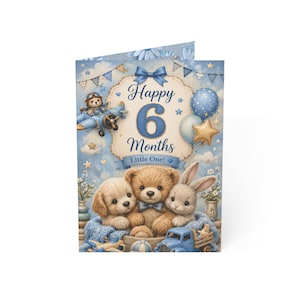 May include: A blue and white greeting card with the text "Happy 6 Months Little One!" features illustrations of a teddy bear, puppy, and bunny. The card also includes a toy airplane, balloons, and stars.