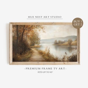 Könnte beinhalten: Ein rechteckiges gerahmtes digitales Kunstwerk mit dem Titel HUE NEST ART STUDIO, das eine Landschaftsmalerei mit einem Weg entlang eines Sees, herbstlichen Bäumen und Hügeln zeigt. Der Rahmen enthält den Text BUY 1 GET 2, PREMIUM FRAME TV ART, FITS UP TO 85".