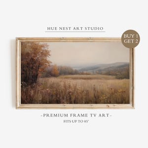 May include: A rectangular landscape painting in a light wood frame featuring a field of tall grasses, autumn trees, and distant hills under a hazy sky. Text reads: HUE NEST ART STUDIO, BUY 1 GET 2, PREMIUM FRAME TV ART, FITS UP TO 85 INCHES.