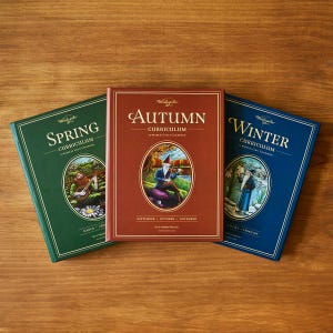 May include: Three hardback books titled "Spring", "Autumn", and "Winter" are arranged on a wooden surface. The books feature colourful covers with illustrations and text, including the word "Curriculum" and seasonal months.