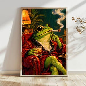 May include: A framed painting of a green frog sitting in a red leather armchair, wearing a red patterned robe. The frog holds a glass of amber liquid and a lit cigarette with rising smoke. A yellow lamp and green plants are in the background.