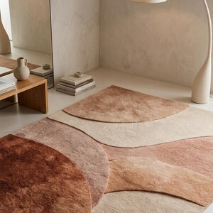 May include: A set of three ceramic mugs with a speckled, matte finish. The mugs are in shades of cream, light gray, and dark gray. Each mug has a simple, minimalist design, perfect for coffee or tea.
