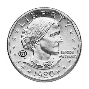 May include: A silver coin featuring a profile of a woman, with the word "LIBERTY" at the top. The coin also includes the text "IN GOD WE TRUST" and the year "1980". The coin has a star-shaped border.