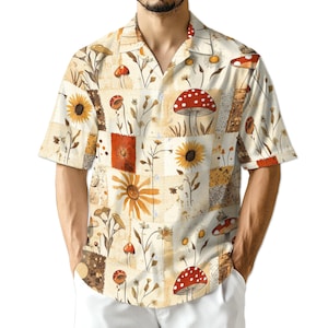 Puede incluir: Camisa de manga corta con diseño de patchwork. Presenta girasoles, setas y elementos florales en tonos beige, marrón, naranja y rojo. Tiene cuello clásico y corte relajado, adecuada para uso casual.