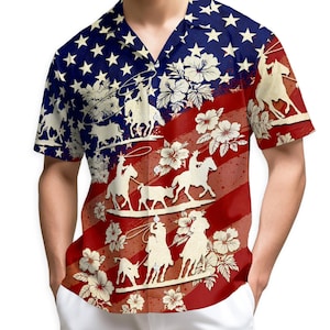 May include: Short-sleeved button-down shirt with a patriotic design. The shirt features a blue background with white stars, red and white stripes, and cowboy silhouettes. White hibiscus flowers are also present in the design.