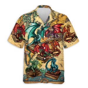 May include: Short-sleeved button-down shirt featuring a vintage world map design. The shirt is adorned with colorful illustrations of dragons perched on stacks of books. The dragons have wings in shades of red, green, blue, and purple.