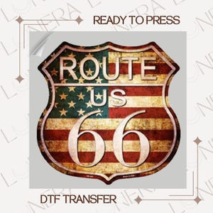 May include: A distressed Route 66 shield design featuring the American flag. The shield has the words "ROUTE US 66" in white, with the numbers "66" in a large font. The words "READY TO PRESS" and "DTF TRANSFER" are also visible.
