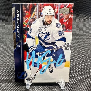 May include: A set of three ceramic mugs with a speckled, matte finish. The mugs are in shades of cream, light gray, and dark gray. Each mug has a simple, minimalist design, perfect for coffee or tea.