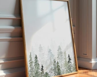 Pode incluir: Uma impressão de arte emoldurada com uma cena de floresta em aquarela. A obra retrata árvores perenes em tons de verde e cinza sobre um fundo branco. A moldura é de madeira clara.