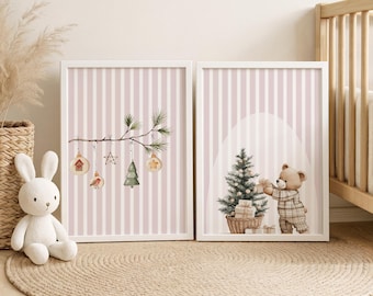 May include: Two framed watercolor prints with a Christmas theme. One features a branch with ornaments, the other a teddy bear with gifts by a Christmas tree. The background is pink and white striped.