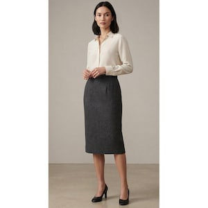 May include: A long-sleeved cream button-down shirt with a collar and a dark grey knee-length pencil skirt. The shirt features a front button placket and cuffed sleeves, while the skirt has a straight, tailored fit with a clean, solid texture.