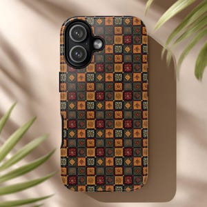 May include: A phone case with a repeating pattern of small, square tiles in shades of black, gold, red, and green. The case has a camera cutout and a black border.