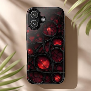 May include: A black smartphone case with a stained glass design. The case features a pattern of dark, irregular shapes with red, glowing centers. The design is reminiscent of a gothic stained glass window.
