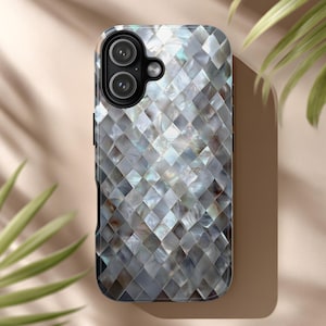 May include: A smartphone case with a mosaic pattern. The case features a repeating diamond pattern in shades of gray, white, and iridescent hues. The camera lenses are visible at the top. The case is designed to protect the phone.